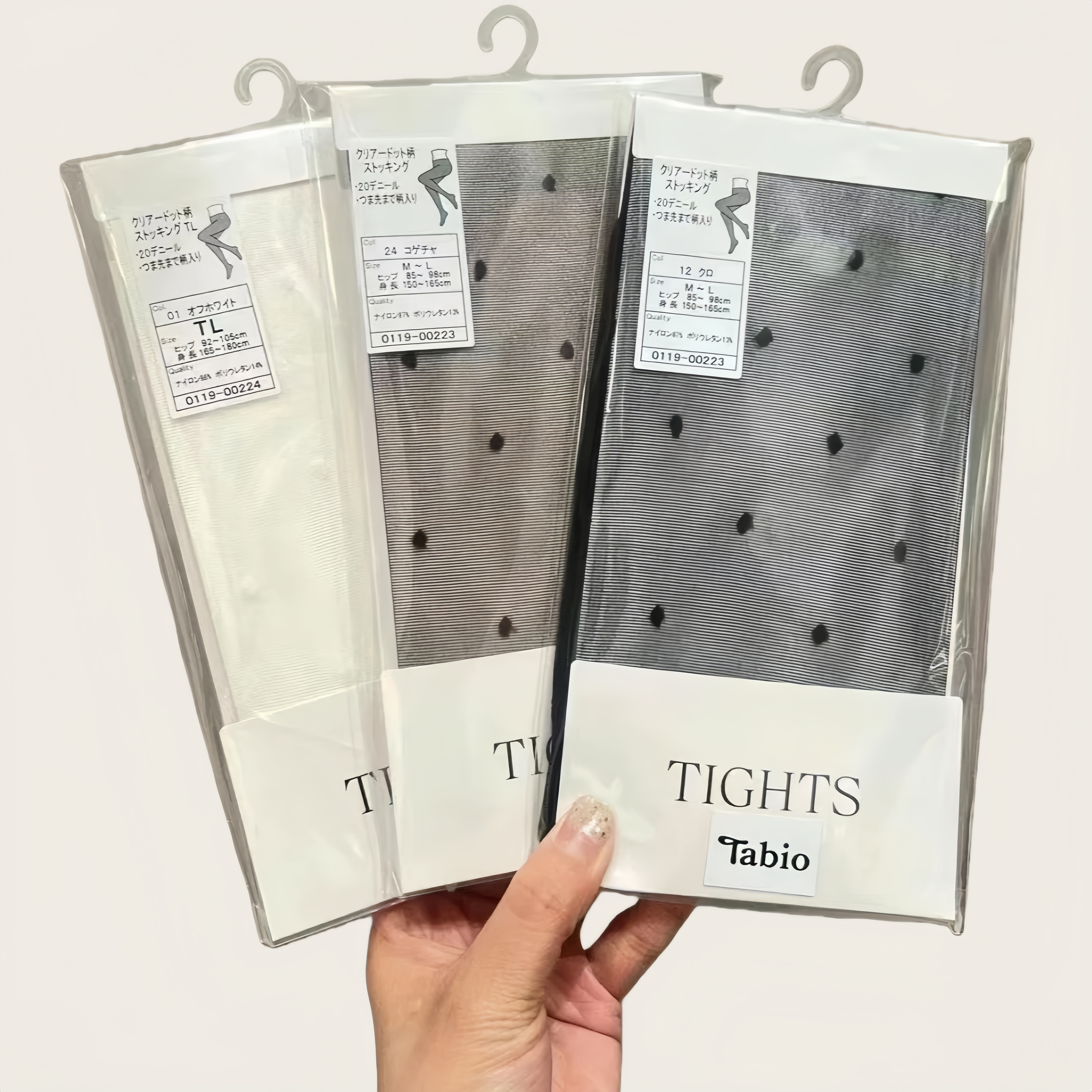 Elegant packaging of sheer nylon tights with product label and care instructions, minimal aesthetic design for online retail display.
